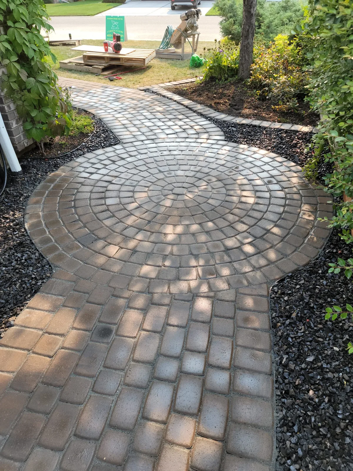 Completed Scenic Acres landscaping project with a circular paving stone patio